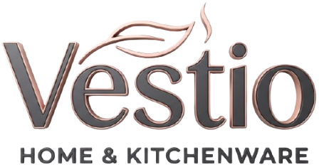 Vestio Home & Kitchenware logo on a plain white background, with the brand name in dark gray and a stylized leaf graphic in a warm metallic copper tone above the wordmark.